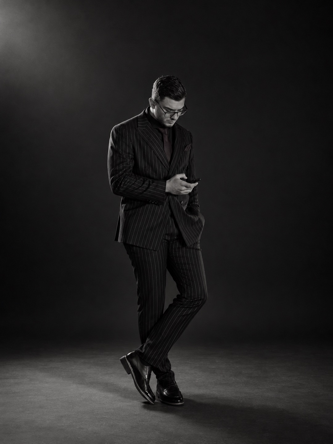 Black-and-white studio edit of Yiğit Akalın’s original photograph in a pinstripe suit